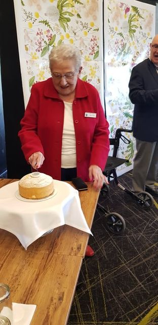 Pam cutting birthday cake